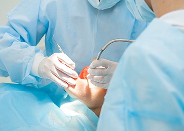 dentist performing oral surgery