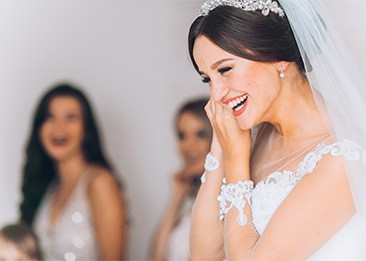 Bride smiling while putting on earring