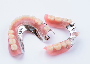 Set of partial dentures on white surface