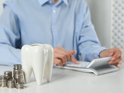 A patient using a calculator to learn the cost of dental emergencies