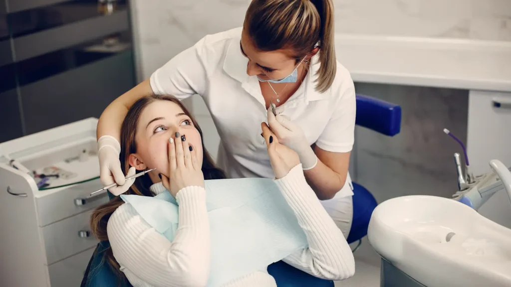 beautiful girl sitting dentist s office 1 - Dentique Dental Care