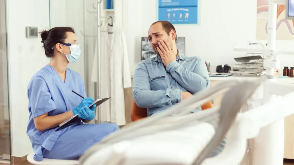 dental assistant writing stomatology treatment clipboard dental clinic sick patient check up 1 1 - Dentique Dental Care